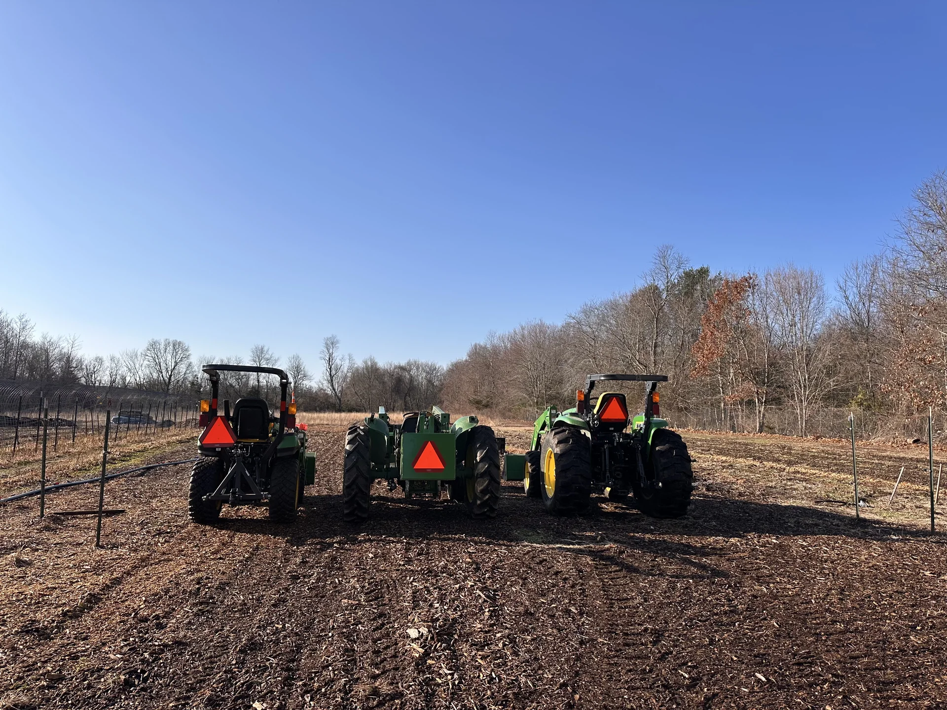 Three tractors lined up in the Giving Garden field